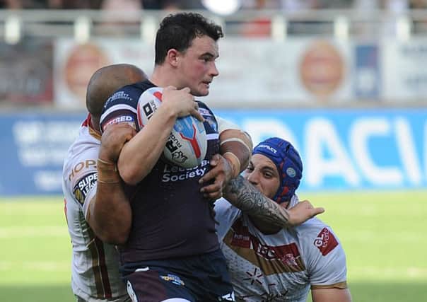 Jordan Lilley is tackled by the Catalans Dragons defence.