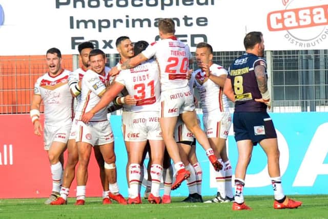 Catalans Dragons celebrate a try against Leeds Rhinos.